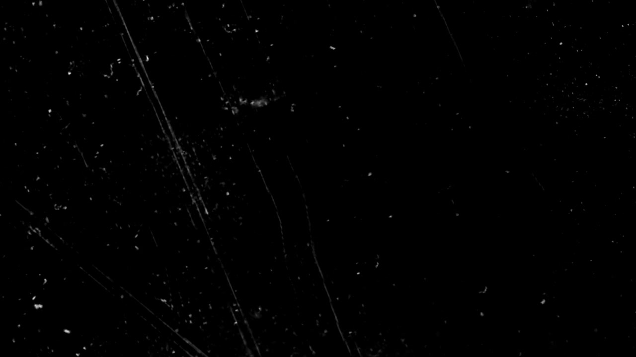 Vintage Film Scratches and Dust Overlay on Black Background