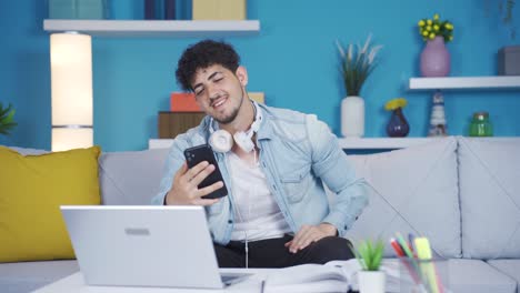 Young-student-video-chatting-with-his-friend-on-the-phone.