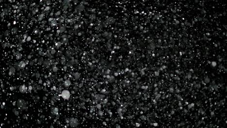 slow motion snow on black background