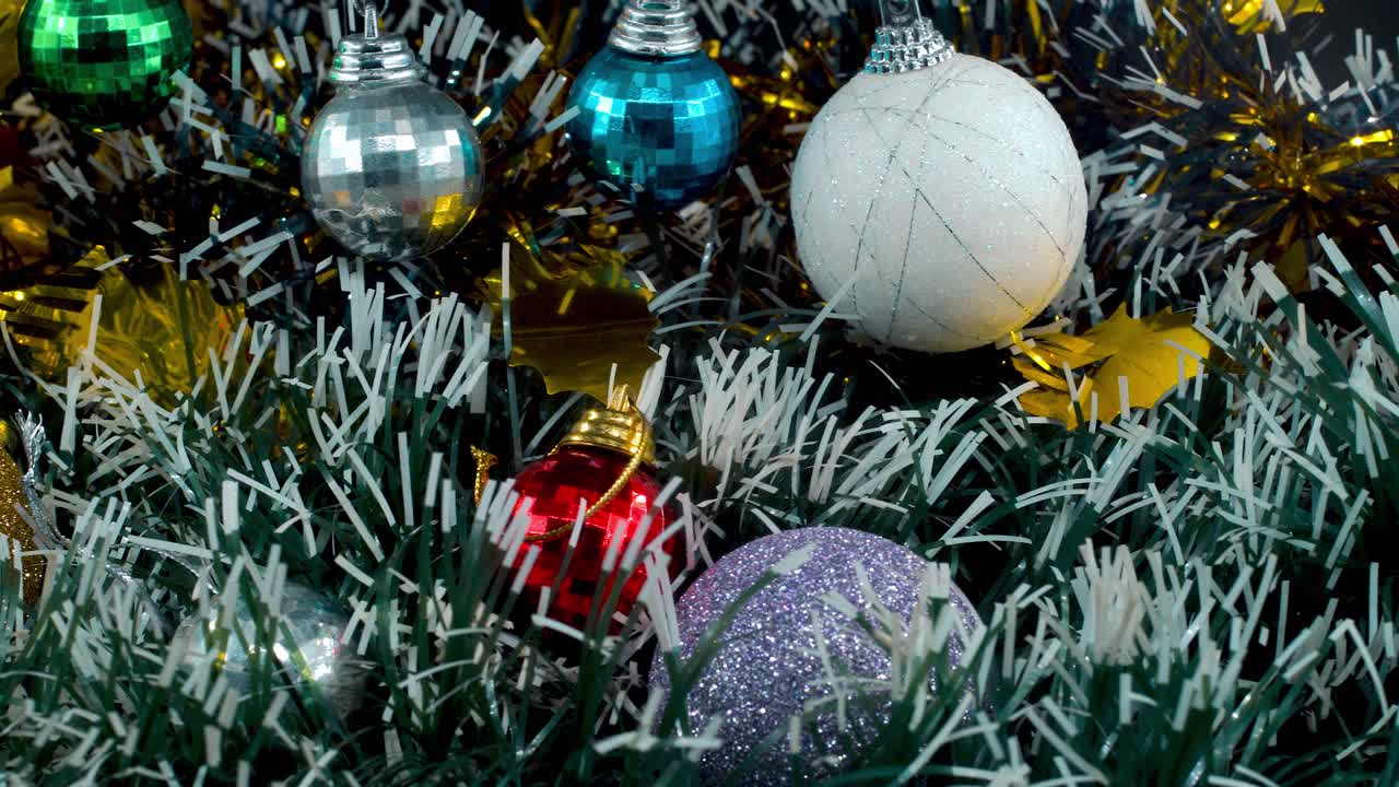 hermosa decoración de navidad, coloridos adornos colgantes, colores azul verde blanco oro, año nuevo decorado, luces brillantes, cinematográfico primer plano pan izquierda video 4k