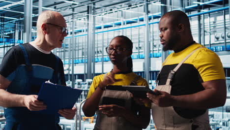 smart factory team leader talking with employees monitoring system performance