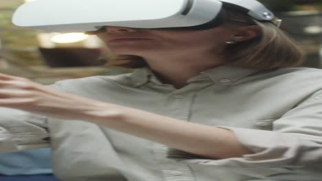 woman interacting with virtual reality headset