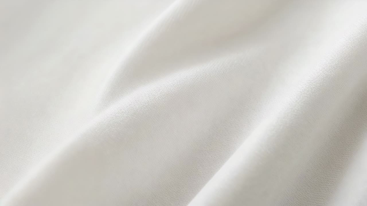 Showing white cloth shifting in studio crop, with soft directional light shifting, showing folds