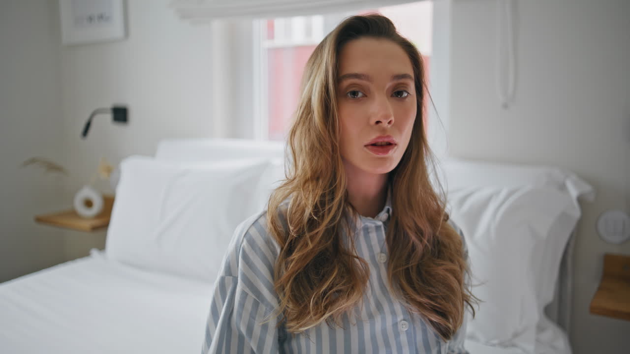 Sad lady waiting message holding smartphone in bedroom closeup. Unhappy woman