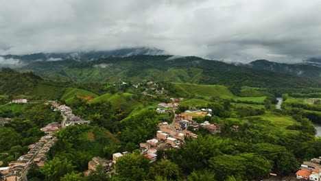 aerial view over houses and roads in the mountains of san rafael, cloudy colombia