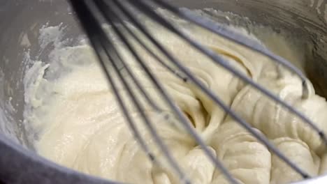 Mixing-Waffle-Batter-In-A-Bowl-With-Whisk---close-up,-slow-motion
