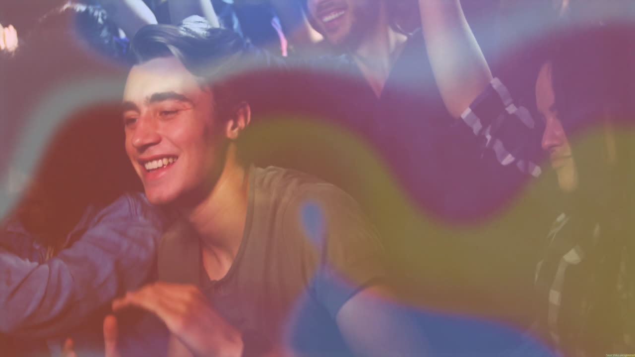 Group of friends dancing in music industry club, with animated colorful light streaks flashing