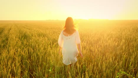 Woman Running Through Wheat Field at Sunset