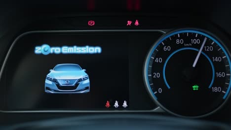 starting electric car dashboard. track in to the button. finger press the button to start the car engine. car dashboard during start engine on the darkness