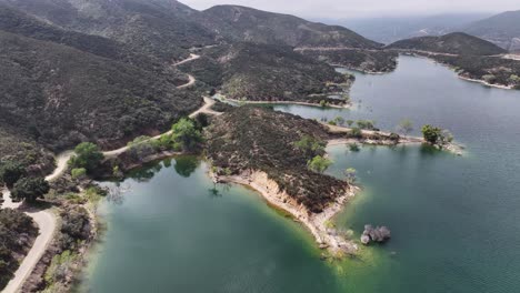 small island on bouquet reservoir in santa clarita southern california on a moody day aerial trucking pan 60fps