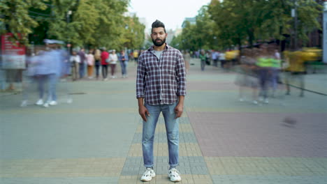 man standing on city street