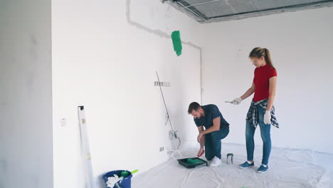 woman-touches-boyfriend-with-brush-flirting-in-light-room