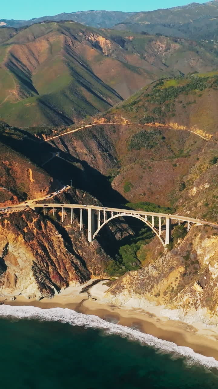Bixby Creek Bridge on the Big Sur coast of California. Aerial view of big bridge on rocky landscape. Vertical video