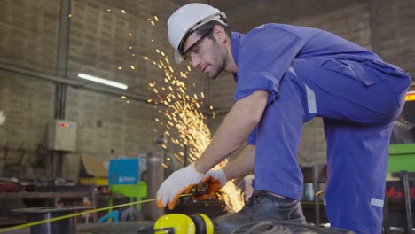 caucasian male worker in a safty uniform wear welders leathers,qc cheching and measurement with electric wheel grinding on steel structure in factor in the garage, orange bokeh sparks fly to the sides