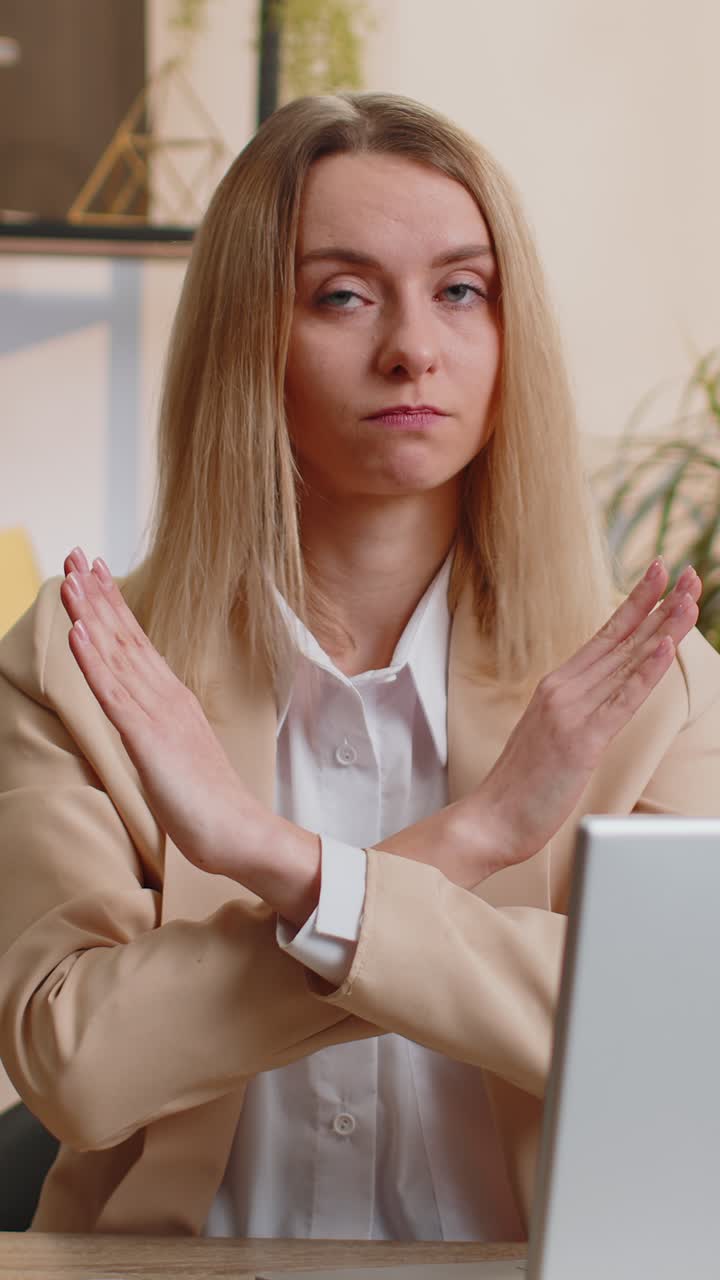 Businesswoman working on laptop showing stop gestuge danger rejection warning crisis prohibition