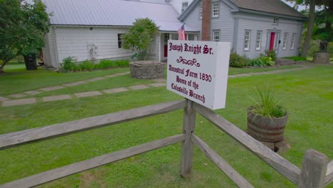 Sign-on-the-front-of-the-home-Drone-shot-of-the-Joseph-Knight-Sr-home-in-Mormon-history