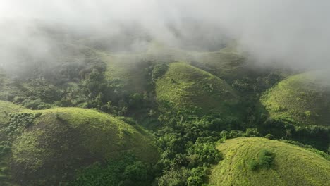 aerial footage - fog over green hills - indonesia