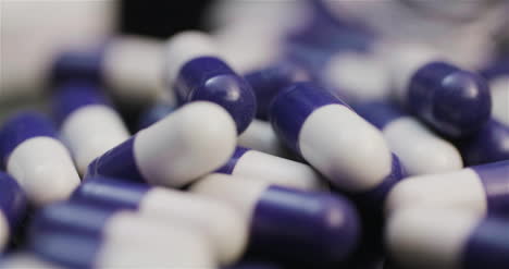 Medicine-Pharmacy-Concept-Extreme-Close-Up-Of-Pills-Rotating-On-Black-Background-