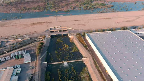 santa fe dam filled to the rim after historically high rainfall in 2023 - tilt down aerial reveal