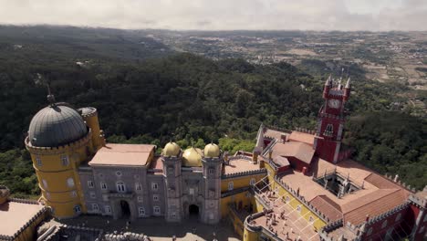 pull out reveal shot of colorful facade romanticist castle, national palace of pena in sintra portugal