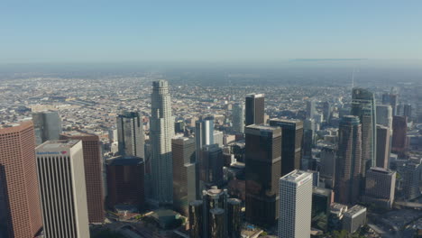 High-above-rooftops-of-City-Skyscrapers-in-Big-Cityscape-of-Los-Angeles,-California-in-beautiful-sunlight