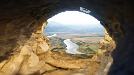 aerial view of a winding river in a mountain valley