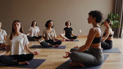 women in yoga meditation session