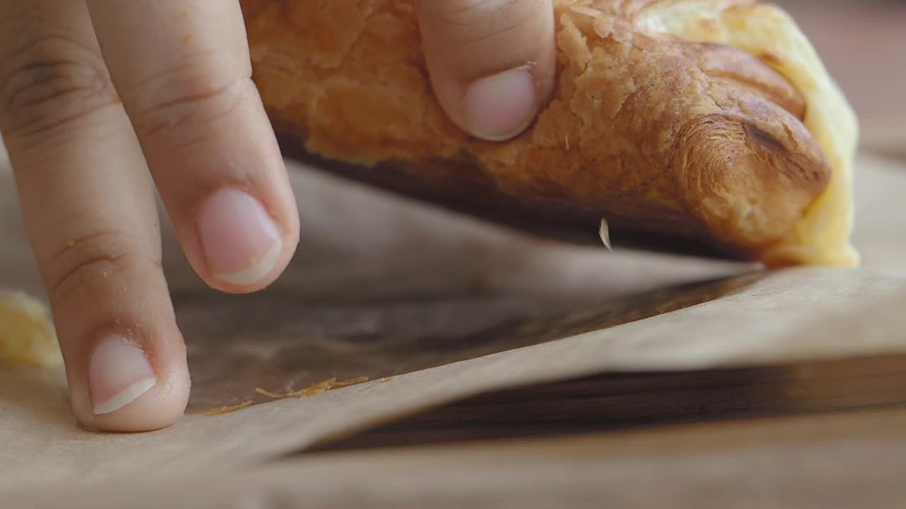 Close-up of a hand touching a pastry