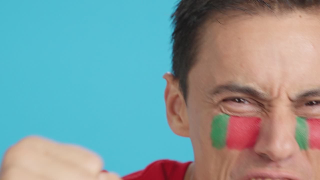 Close up of a man supporting portuguese team
