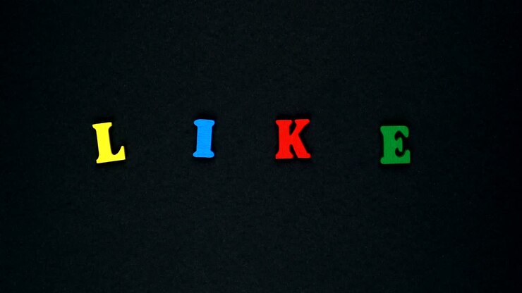 Word "like" formed of wooden multicolored letters. Colorful words loop.