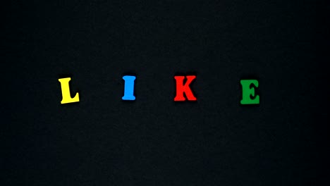 word "like" formed of wooden multicolored letters. colorful words loop.