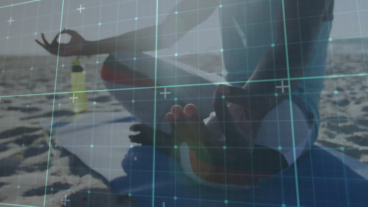 Meditating on beach, person with digital grid overlay creating animation effect