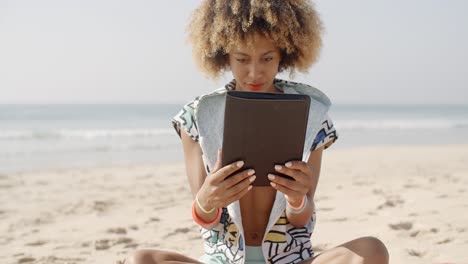 Girl Using Tablet Pc At The Beach