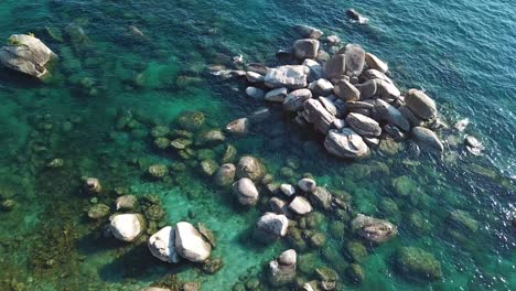 Ziehen-Sie-Die-Drohnenluftaufnahme-Auf-Der-Farbenfrohen-Küste-Von-Lake-Tahoe,-Dem-Klaren-Blauen-Alpenwasser-Und-Dem-Grünen-Evegreen-Wald,-USA-Hoch