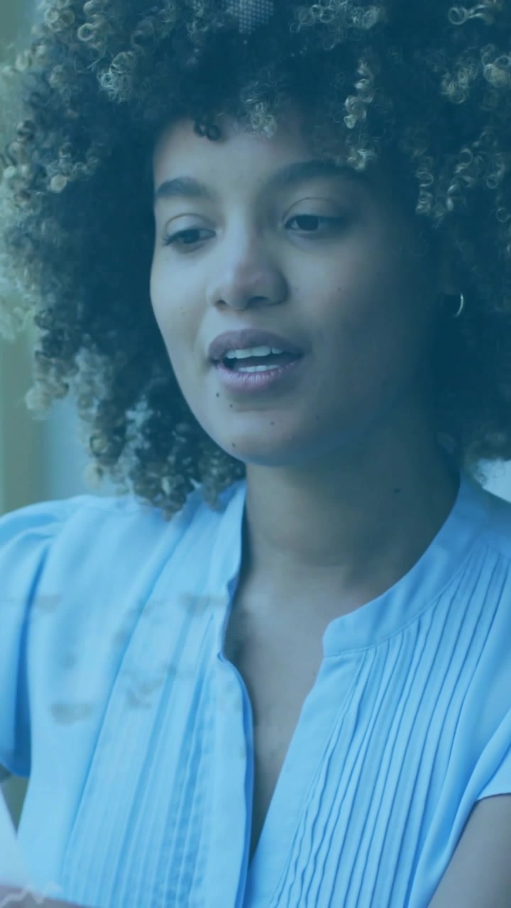 Vertical video: Woman picking paper and reading for business adjusting glasses with projected lines