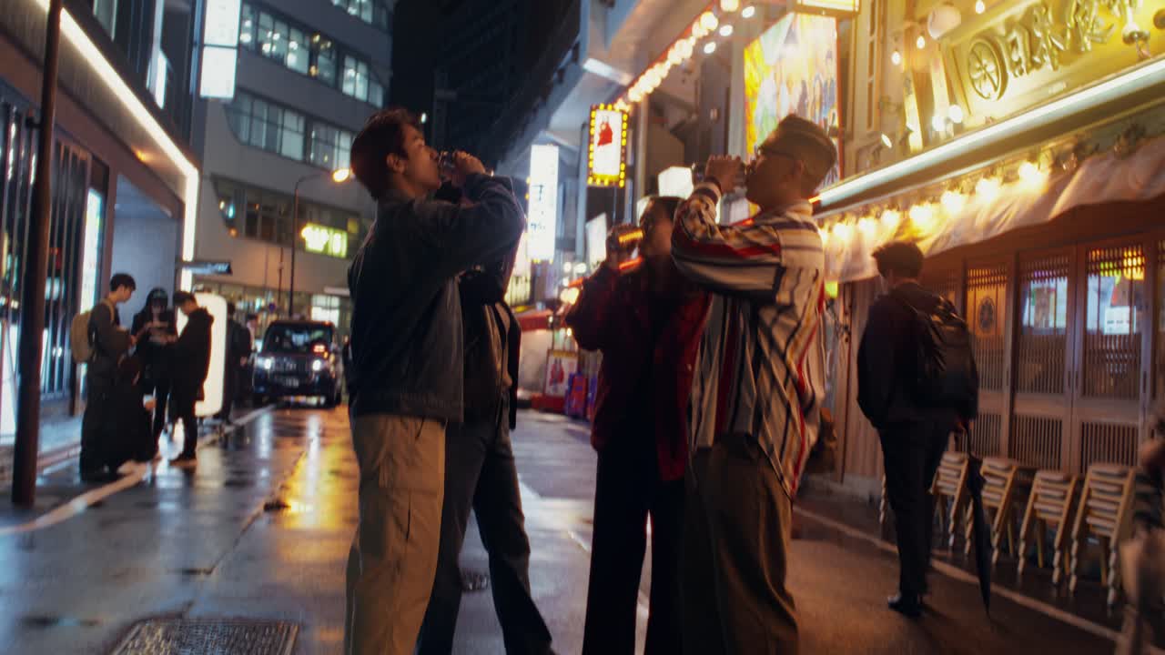 Friends Drinking in a Night Street Scene in Japan