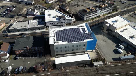 an aerial view of an office building with solar panels on the roof on a sunny day