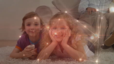 Lying-on-carpet-with-remote-control,-children-watching-network-connections-animation