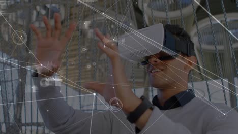 Animation-of-network-of-connections-over-businessman-using-vr-headset