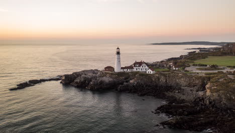 scenic aerial timelapse of portland head light, maine, with moving water and beautiful sunrise