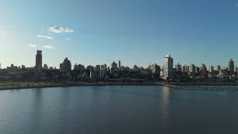 aerial establishing of posadas misiones south american town, skyline silhouette over argentine waterfront city