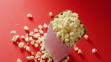 video of close up of popcorn on red background