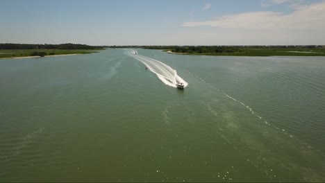 flying over boats in the intracoastal waterway during middle of the day in the summer on a sunny day