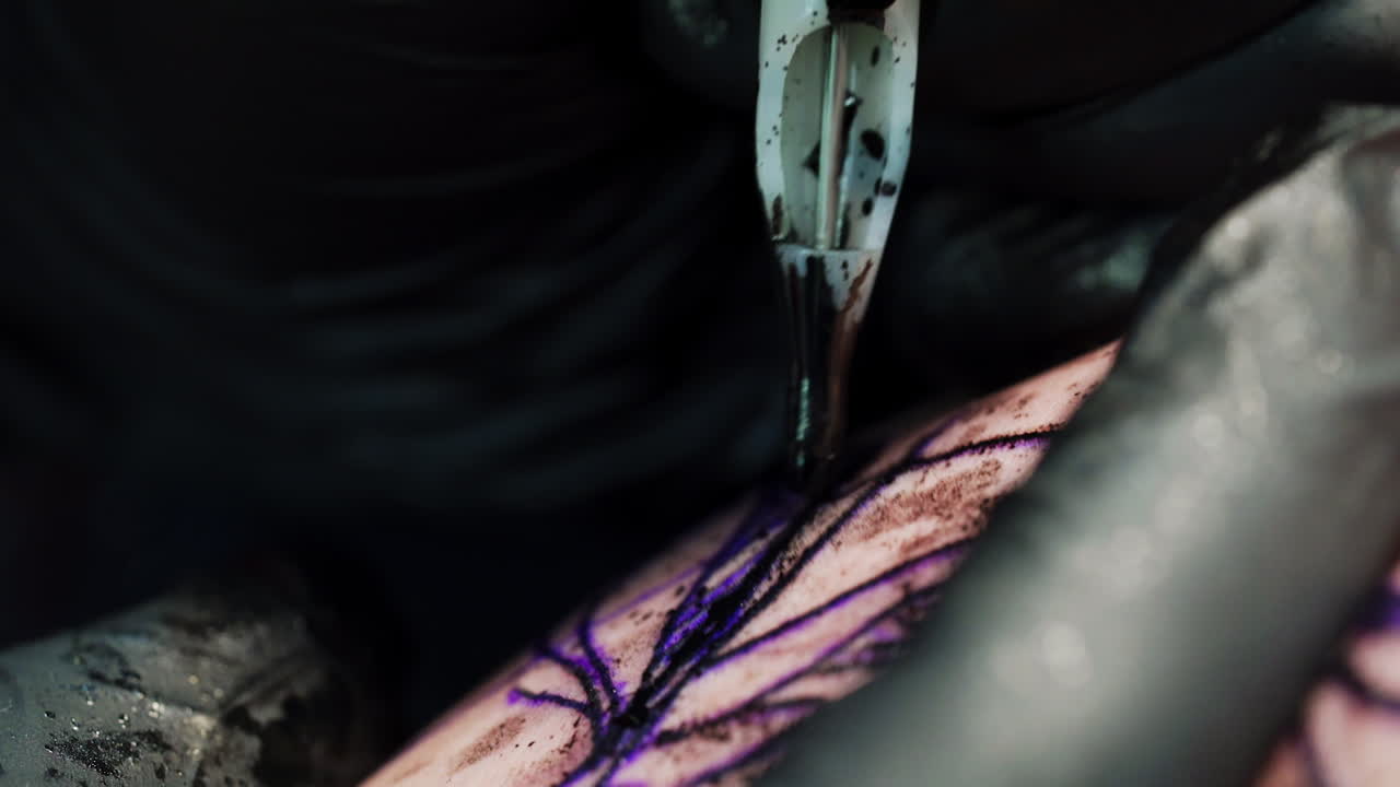 Process of getting tattoo in the salon. Place of future tattoo is spotted with ink. Close up.
