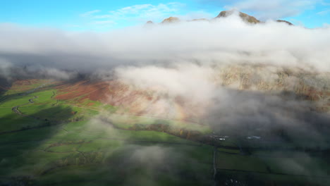 mountaintops poking out from cloud layer lit by early morning autumn sunlight