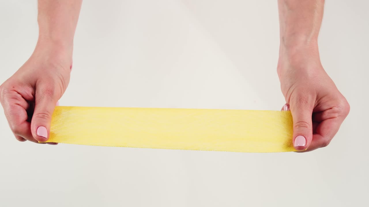 Kinesiology medical taping, doctor Physical therapist applying elastic surgical tape to patient body, treating injured knee young athlete.Post traumatic rehabilitation, sport physical therapy recovery