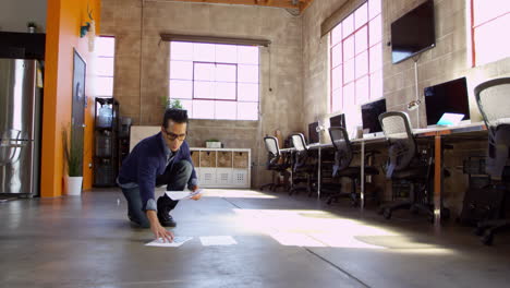 designer plans layout on floor of modern office shot on r3d