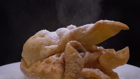 sprinkling angel wings, faworki with powdered sugar