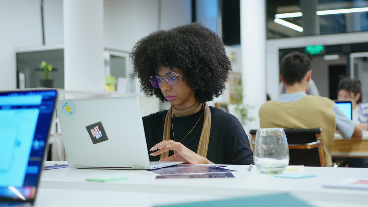 Young Black Woman Working on Laptop in the Office