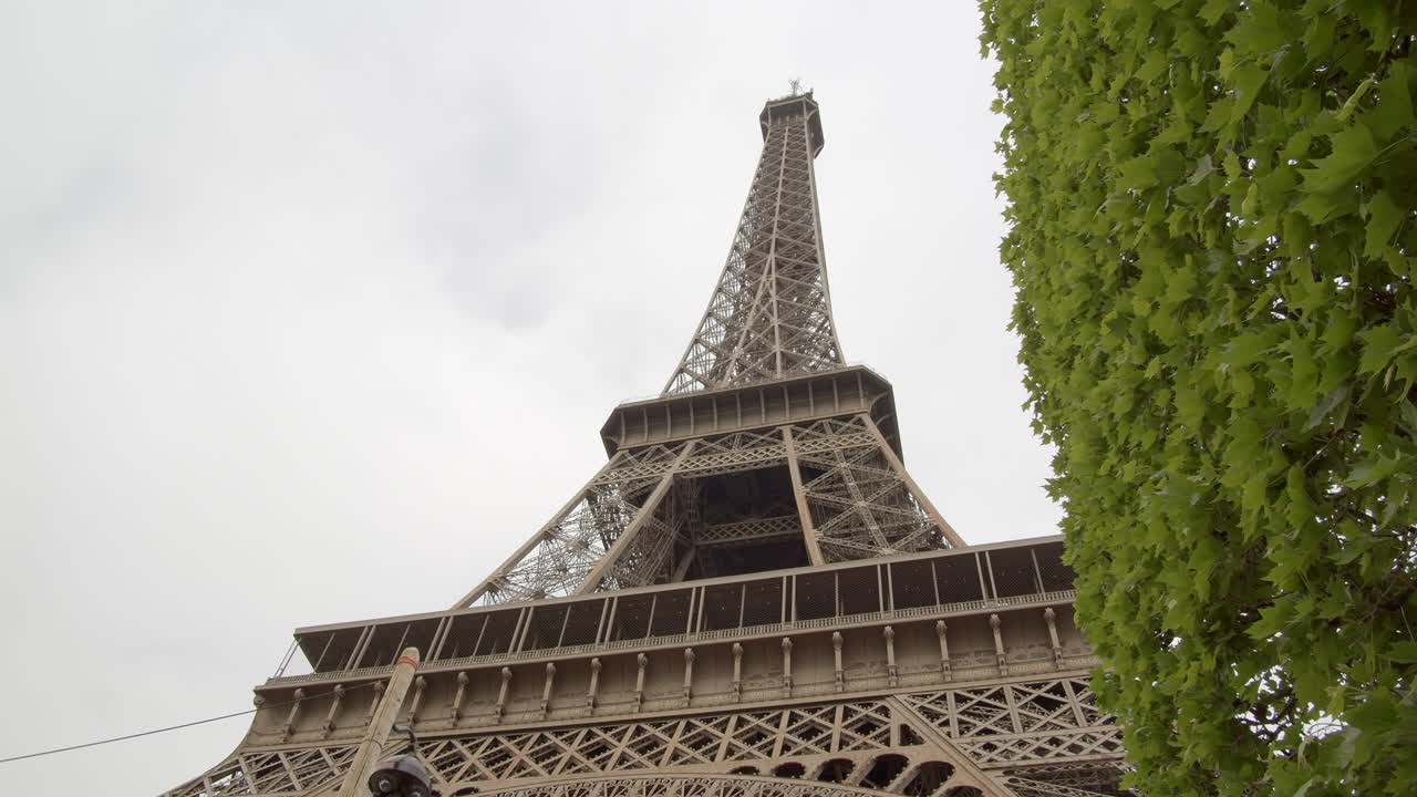 Close up from below the Eiffel Tower on a cloudy day.